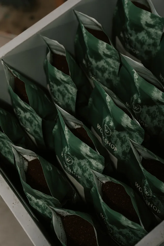 Crate of green Workshop Coffee bags