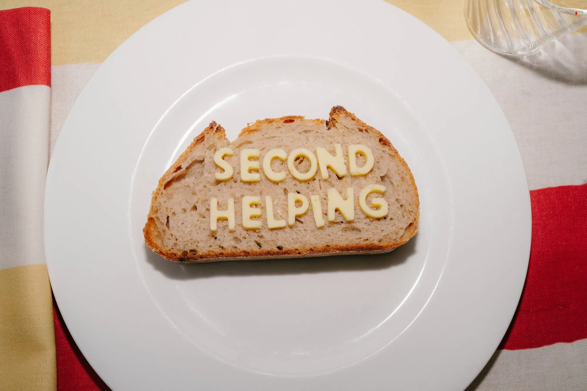 Second Helping — toast with butter lettering